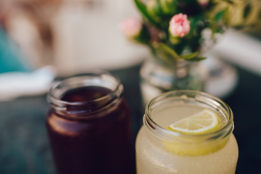 Juice Cleanse Guide: Refresh Your Body & Mind in 2024 46 clear glass mason jar with lemon slice on top of cocktail