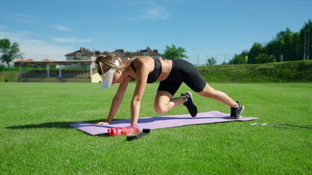 Woman doing mountain climber exercise outdoors