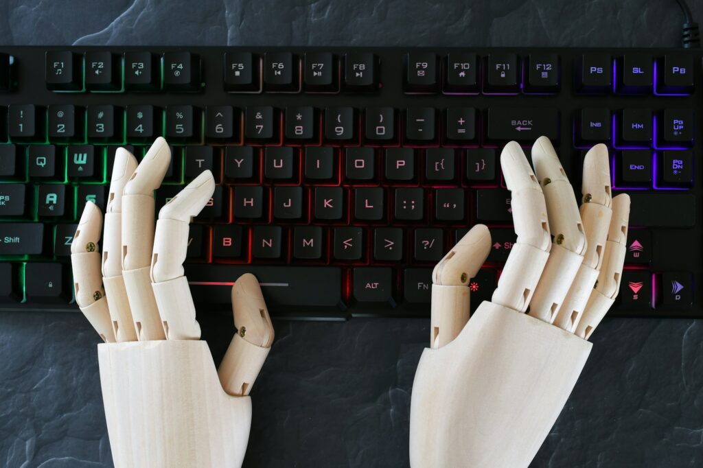 5 AI Tools to Skyrocket Engagement and Efficiency on your blog! 2 AI artificial intelligence concept - robot hands typing on lit keyboard